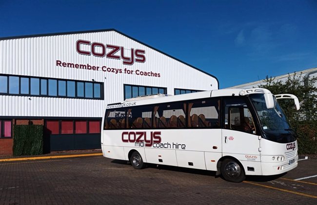 Cozys 21-seat midi coach CO10 ZYO outside the Cozys depot
